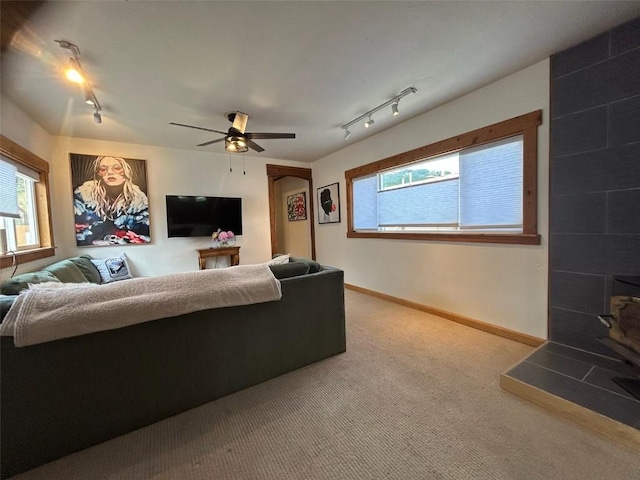 1325 Dream Island Plz Unit 55, Steamboat Springs, CO 80487 - living area featuring track lighting, carpet flooring, healthy amount of natural light, and a ceiling fan