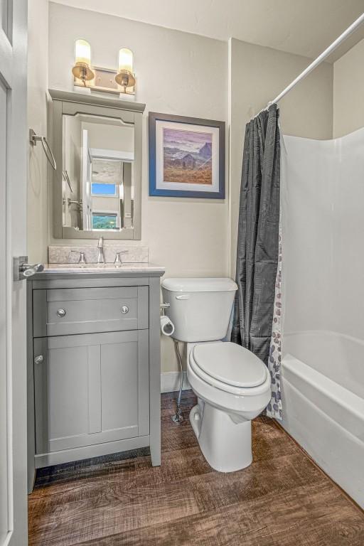 1800 Burgess Creek Rd SW Unit 209, Steamboat Springs, CO 80487 - bathroom with toilet, shower / tub combo with curtain, and vanity