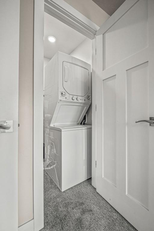 1800 Burgess Creek Rd SW Unit 209, Steamboat Springs, CO 80487 - laundry room featuring estacked washer and dryer and carpet flooring