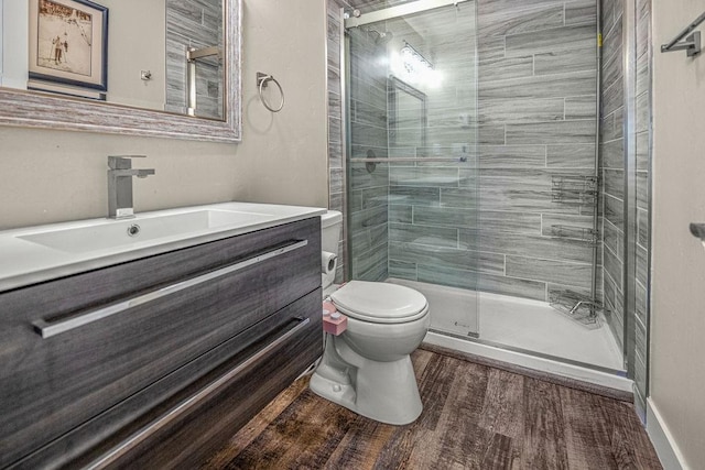 1800 Burgess Creek Rd SW Unit 209, Steamboat Springs, CO 80487 - full bathroom featuring toilet, vanity, a shower stall, and wood finished floors