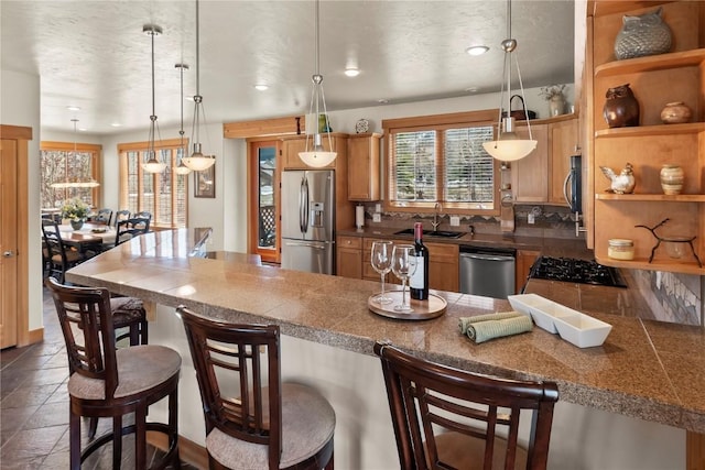 46 Sage View Ct, Dillon, CO 80435 - kitchen featuring a kitchen breakfast bar, appliances with stainless steel finishes, tile countertops, and a sink