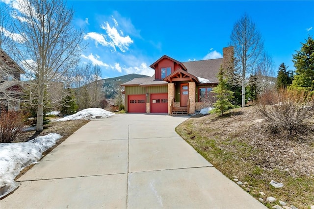 46 Sage View Ct, Dillon, CO 80435 - view of front of home featuring an attached garage, a shingled roof, a chimney, and concrete driveway