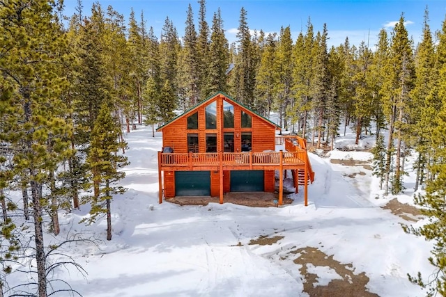 407 S Puma Pl, Fairplay, CO 80440 - view of front of property with a wooden deck, log veneer siding, and an attached garage