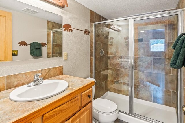 407 S Puma Pl, Fairplay, CO 80440 - full bathroom with toilet, a textured ceiling, visible vents, and a stall shower