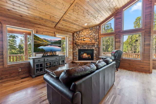 889 Venture Rd, Fairplay, CO 80440 - living area with wooden ceiling, hardwood / wood-style floors, a stone fireplace, high vaulted ceiling, and wood walls