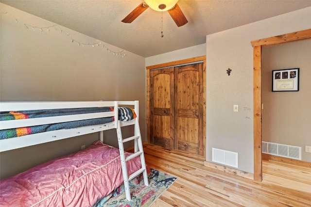 889 Venture Rd, Fairplay, CO 80440 - bedroom with wood finished floors, a ceiling fan, a closet, and a textured ceiling
