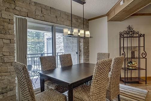 765 Columbine Rd Unit C103, Breckenridge, CO 80424 - dining area featuring a textured ceiling, wood finished floors, and ornamental molding