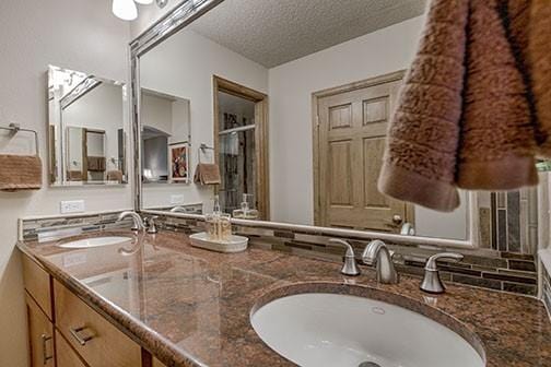765 Columbine Rd Unit C103, Breckenridge, CO 80424 - full bathroom with double vanity and a textured ceiling