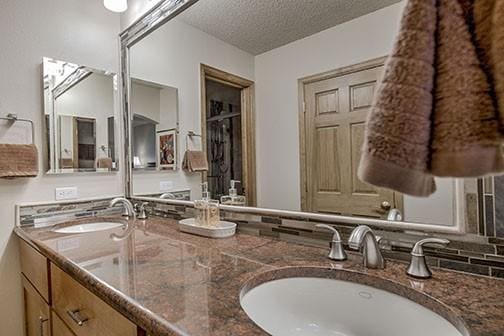 765 Columbine Rd Unit C103, Breckenridge, CO 80424 - bathroom featuring double vanity and a textured ceiling