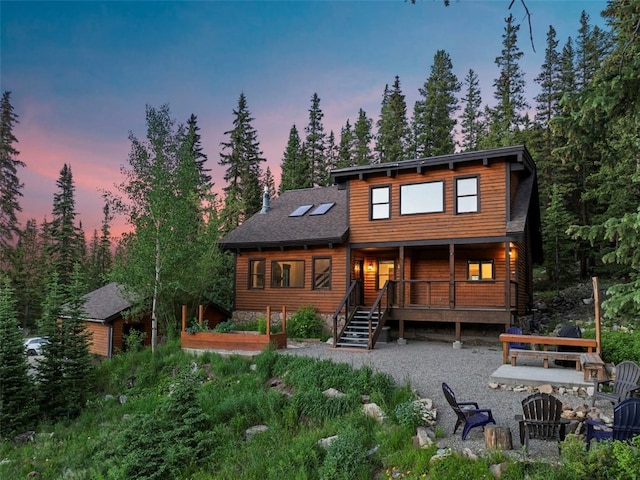 272 Doris Dr, Breckenridge, CO 80424 - back of property featuring a deck, roof with shingles, and a garden