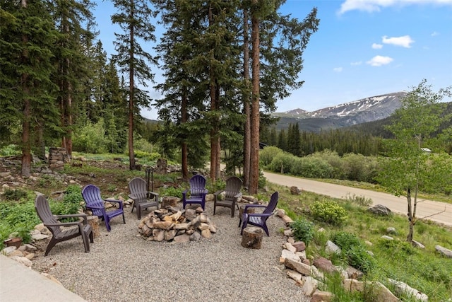 272 Doris Dr, Breckenridge, CO 80424 - view of patio with an outdoor fire pit, a mountain view, and a wooded view