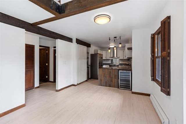 272 Doris Dr, Breckenridge, CO 80424 - kitchen with beverage cooler, a baseboard radiator, freestanding refrigerator, light wood-type flooring, and dark countertops