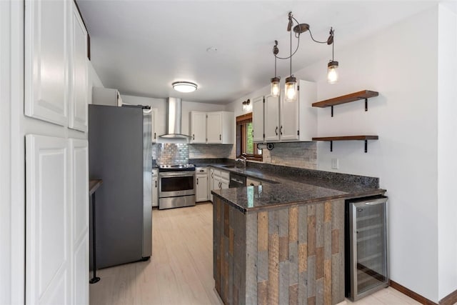 272 Doris Dr, Breckenridge, CO 80424 - kitchen featuring appliances with stainless steel finishes, beverage cooler, wall chimney range hood, a sink, and a peninsula