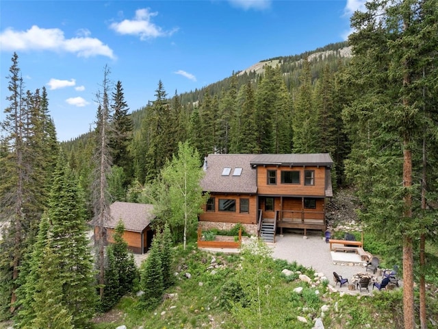 272 Doris Dr, Breckenridge, CO 80424 - rear view of property featuring a forest view, an outdoor fire pit, and covered porch