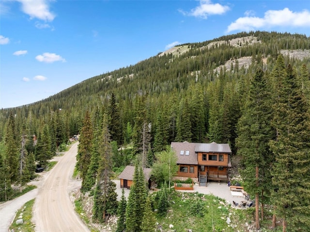272 Doris Dr, Breckenridge, CO 80424 - aerial view of property and surrounding area featuring a heavily wooded area and a mountain backdrop