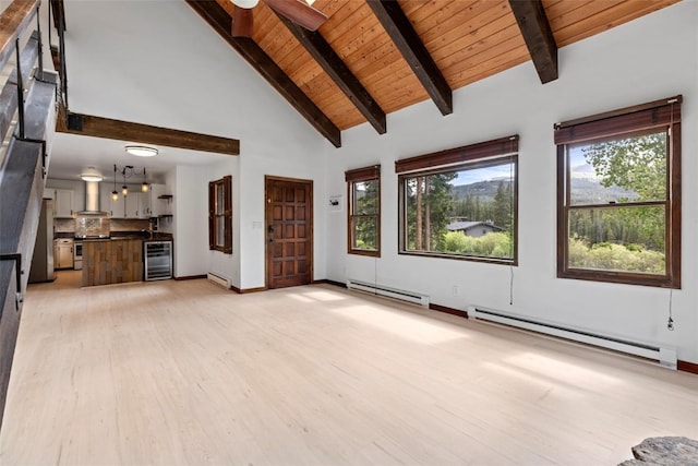 272 Doris Dr, Breckenridge, CO 80424 - unfurnished living room featuring wine cooler, baseboard heating, light wood-style floors, wood ceiling with exposed beams, and high vaulted ceiling