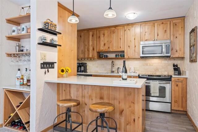 805 Columbine Rd Unit 202, Breckenridge, CO 80424 - kitchen featuring appliances with stainless steel finishes, open shelves, a sink, and tasteful backsplash