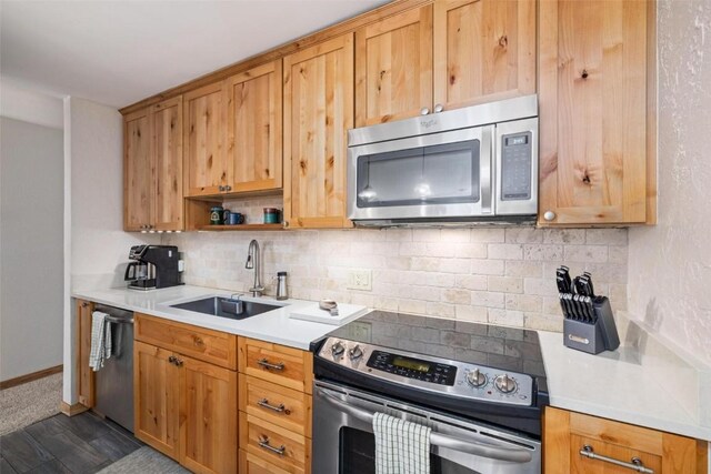 805 Columbine Rd Unit 202, Breckenridge, CO 80424 - kitchen with appliances with stainless steel finishes, a sink, backsplash, and light countertops