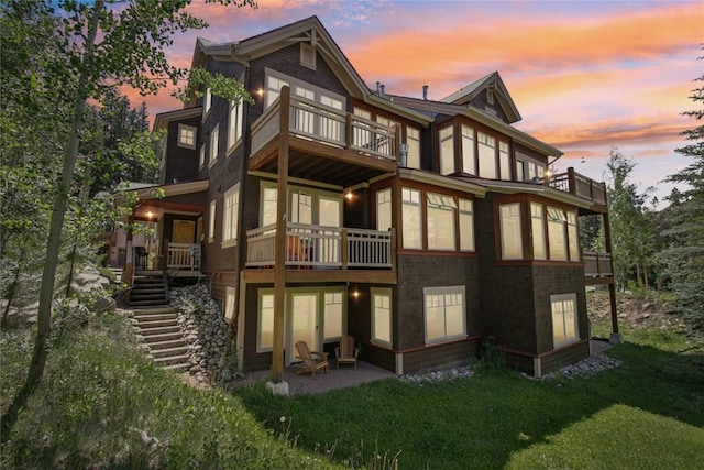 188 Tip Top Trl Unit 6558, Dillon, CO 80435 - back of property at dusk with a balcony, a lawn, a patio, and stairway