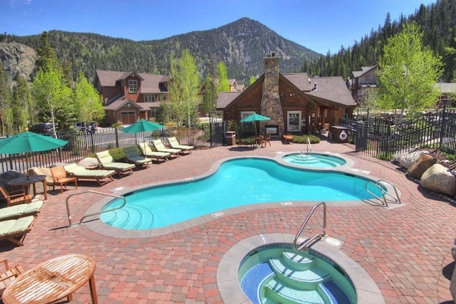 188 Tip Top Trl Unit 6558, Dillon, CO 80435 - community pool with a community hot tub, a mountain view, and a patio area