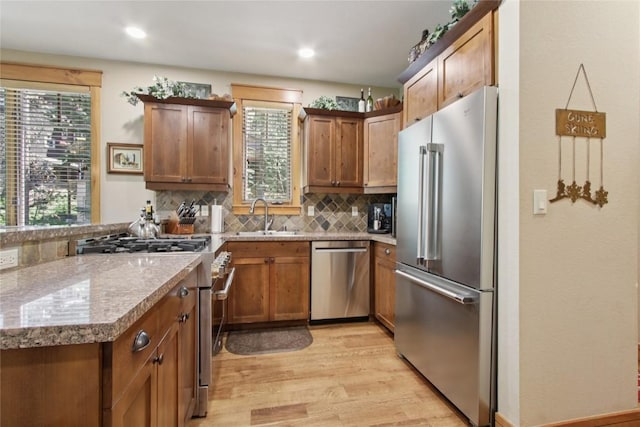 188 Tip Top Trl Unit 6558, Dillon, CO 80435 - kitchen featuring high quality appliances, light wood-style floors, tasteful backsplash, brown cabinetry, and recessed lighting