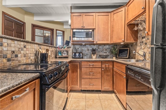 2735 Burgess Creek Rd Unit 11, Steamboat Springs, CO 80487 - kitchen with black appliances, a sink, tasteful backsplash, beamed ceiling, and light tile patterned floors