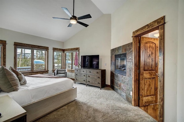 carpeted bedroom with high vaulted ceiling and a ceiling fan