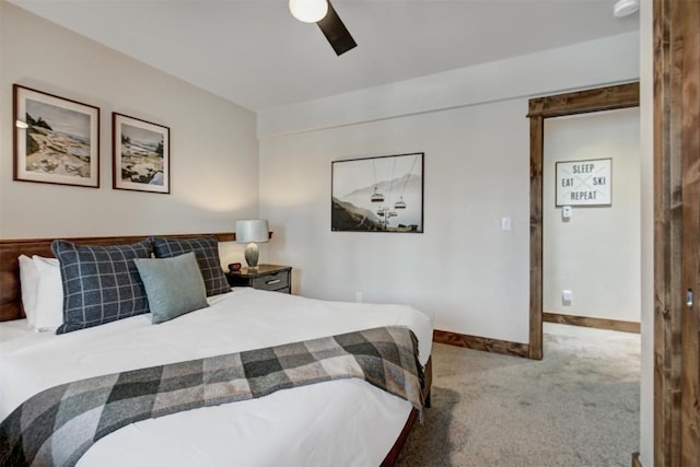 carpeted bedroom featuring baseboards and a ceiling fan