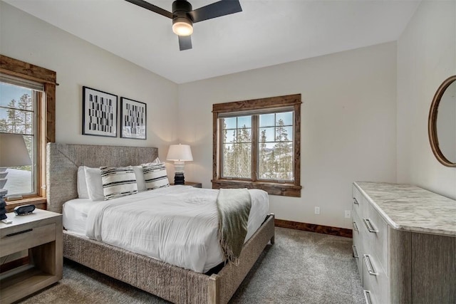 bedroom with dark carpet, a ceiling fan, and baseboards