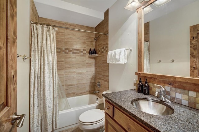 full bath featuring shower / tub combo, vanity, toilet, and tasteful backsplash