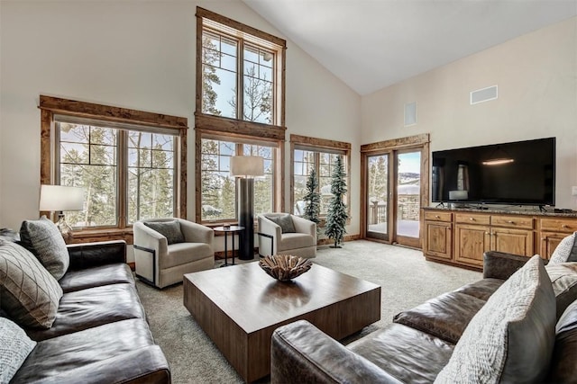 living room featuring light carpet, high vaulted ceiling, and visible vents