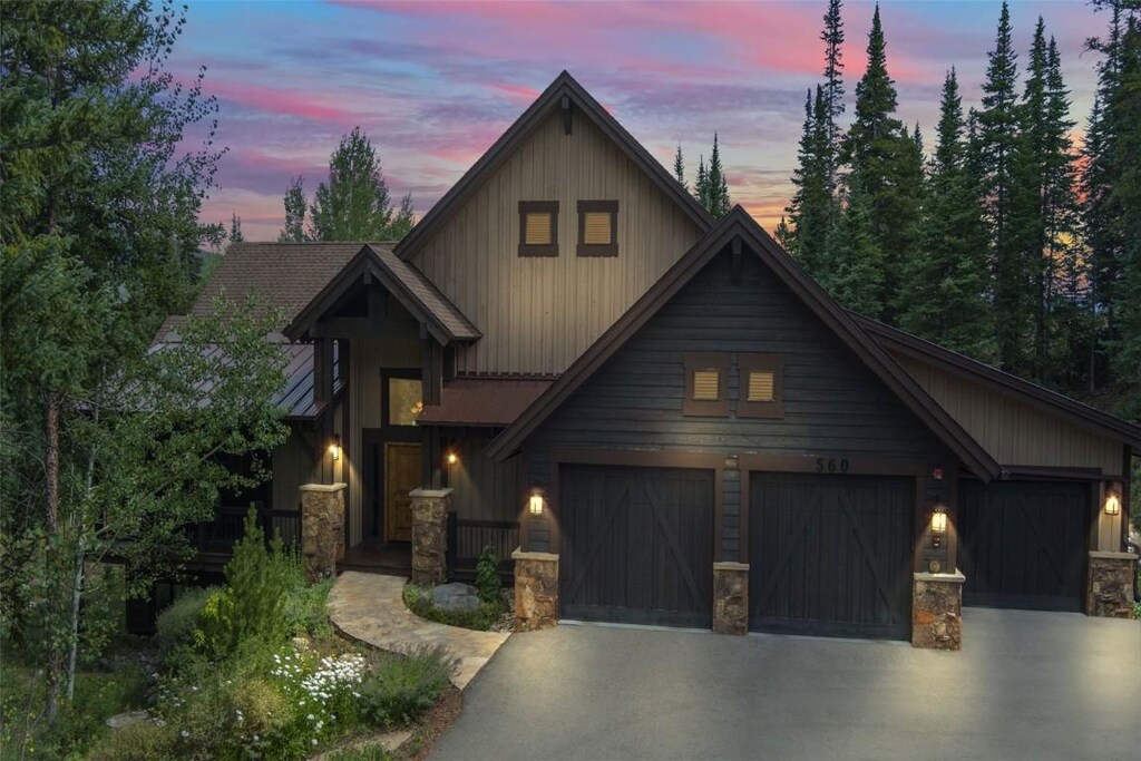 560 Two Cabins Dr, Silverthorne, CO 80498 - craftsman-style house featuring concrete driveway, board and batten siding, and stone siding