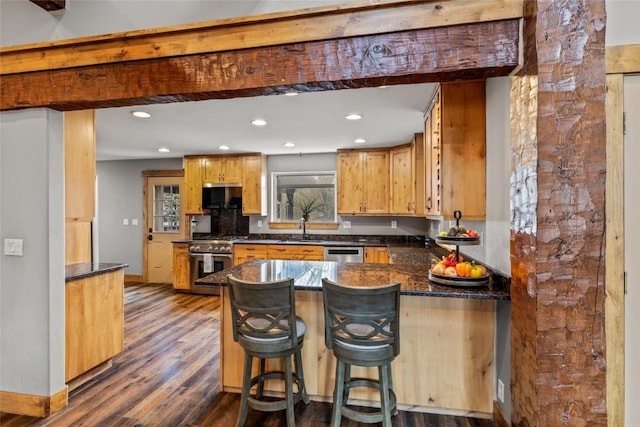 77 Lincoln St, Yampa, CO 80483 - kitchen featuring appliances with stainless steel finishes, a sink, dark wood-style floors, a peninsula, and recessed lighting