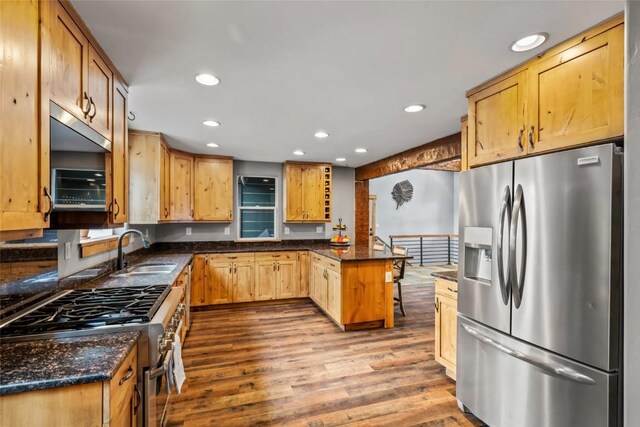 77 Lincoln St, Yampa, CO 80483 - kitchen featuring appliances with stainless steel finishes, a sink, recessed lighting, dark wood-style floors, and a peninsula
