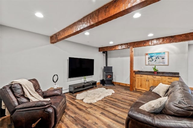 77 Lincoln St, Yampa, CO 80483 - living area featuring a wood stove, beam ceiling, recessed lighting, dark wood-type flooring, and baseboard heating
