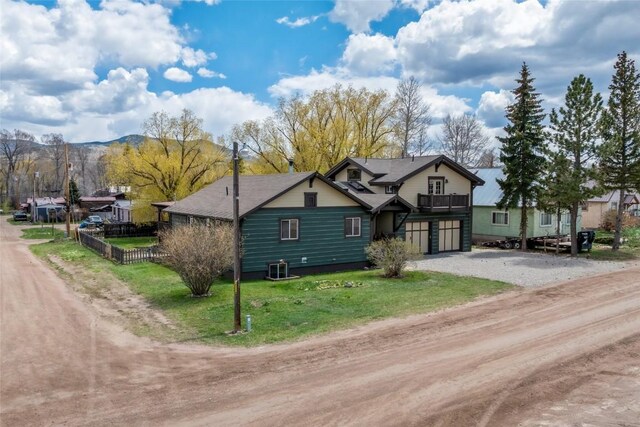 77 Lincoln St, Yampa, CO 80483 - view of front of property with driveway, an attached garage, a mountain view, and a balcony