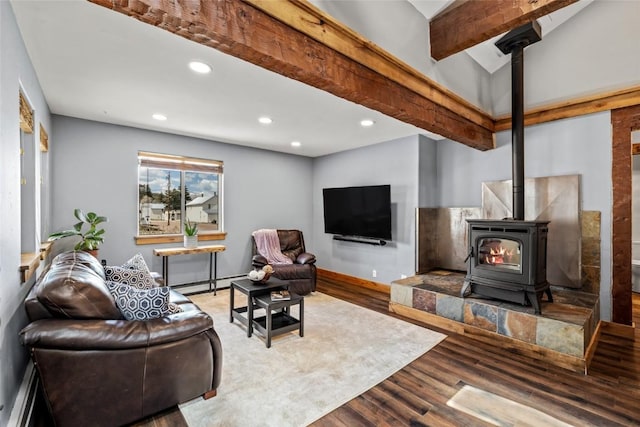 77 Lincoln St, Yampa, CO 80483 - living room featuring a wood stove, wood finished floors, a baseboard radiator, recessed lighting, and baseboards