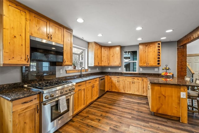 77 Lincoln St, Yampa, CO 80483 - kitchen with appliances with stainless steel finishes, a peninsula, dark wood-style flooring, recessed lighting, and dark stone counters