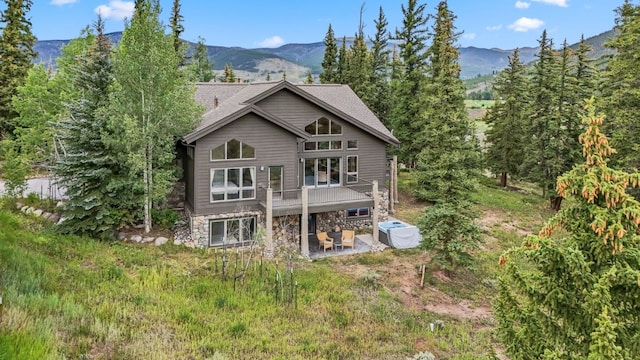 1118 Penstemon Rd, Dillon, CO 80435 - rear view of house with a patio, a deck with mountain view, and stone siding