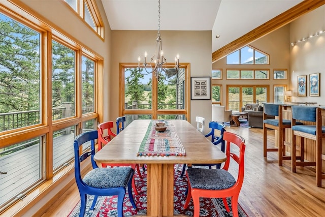 1118 Penstemon Rd, Dillon, CO 80435 - dining room featuring a towering ceiling, a chandelier, and wood finished floors