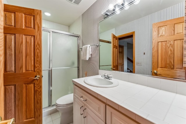 1118 Penstemon Rd, Dillon, CO 80435 - bathroom with toilet, a shower stall, vanity, wallpapered walls, and tile patterned floors