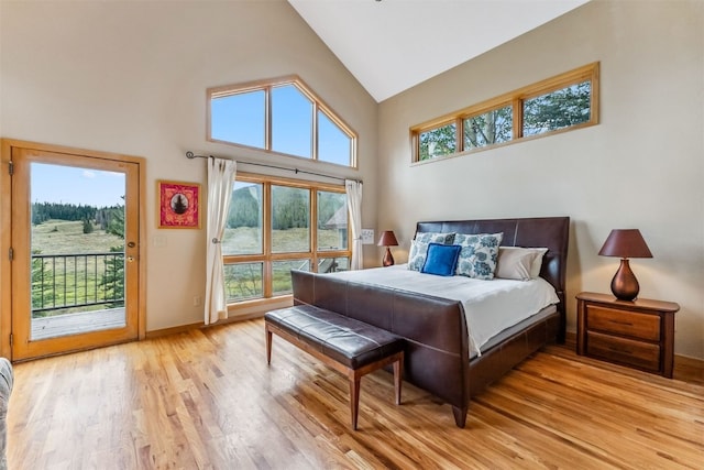 1118 Penstemon Rd, Dillon, CO 80435 - bedroom with access to exterior, high vaulted ceiling, light wood-style floors, and baseboards