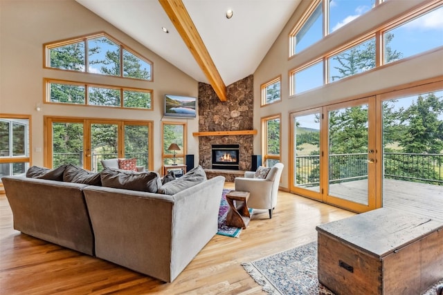1118 Penstemon Rd, Dillon, CO 80435 - living room featuring high vaulted ceiling, a stone fireplace, and wood finished floors