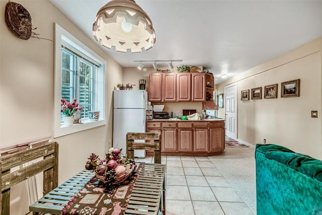 664 Tonkawa Rd, Hartsel, CO 80449 - kitchen featuring freestanding refrigerator, light tile patterned floors, and rail lighting