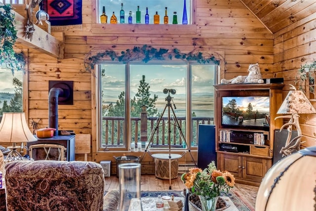 664 Tonkawa Rd, Hartsel, CO 80449 - sitting room featuring hardwood / wood-style floors, vaulted ceiling, wooden walls, wooden ceiling, and a wood stove