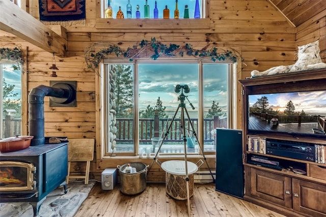 664 Tonkawa Rd, Hartsel, CO 80449 - sitting room featuring wood walls, vaulted ceiling, hardwood / wood-style floors, a wood stove, and healthy amount of natural light
