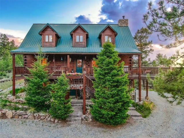 664 Tonkawa Rd, Hartsel, CO 80449 - log home featuring a chimney, a porch, log exterior, and stairway