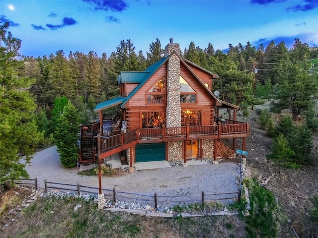 664 Tonkawa Rd, Hartsel, CO 80449 - rear view of property featuring a view of trees, a wooden deck, and log siding