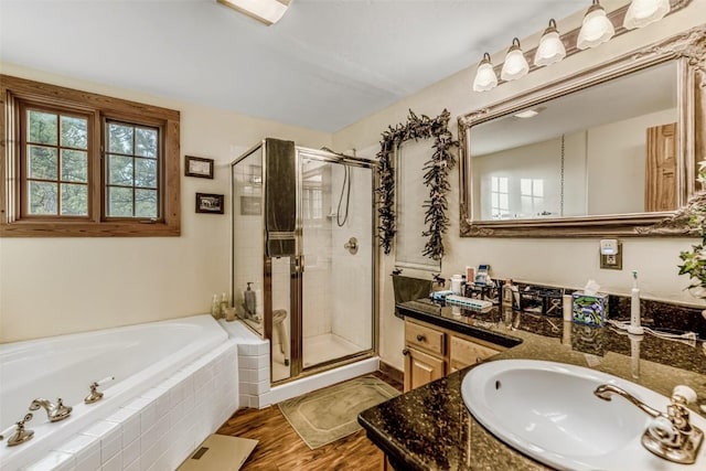 664 Tonkawa Rd, Hartsel, CO 80449 - full bathroom featuring a shower stall, a garden tub, vanity, and wood finished floors