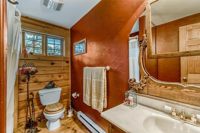 664 Tonkawa Rd, Hartsel, CO 80449 - full bath featuring wood finished floors, a baseboard heating unit, and vanity